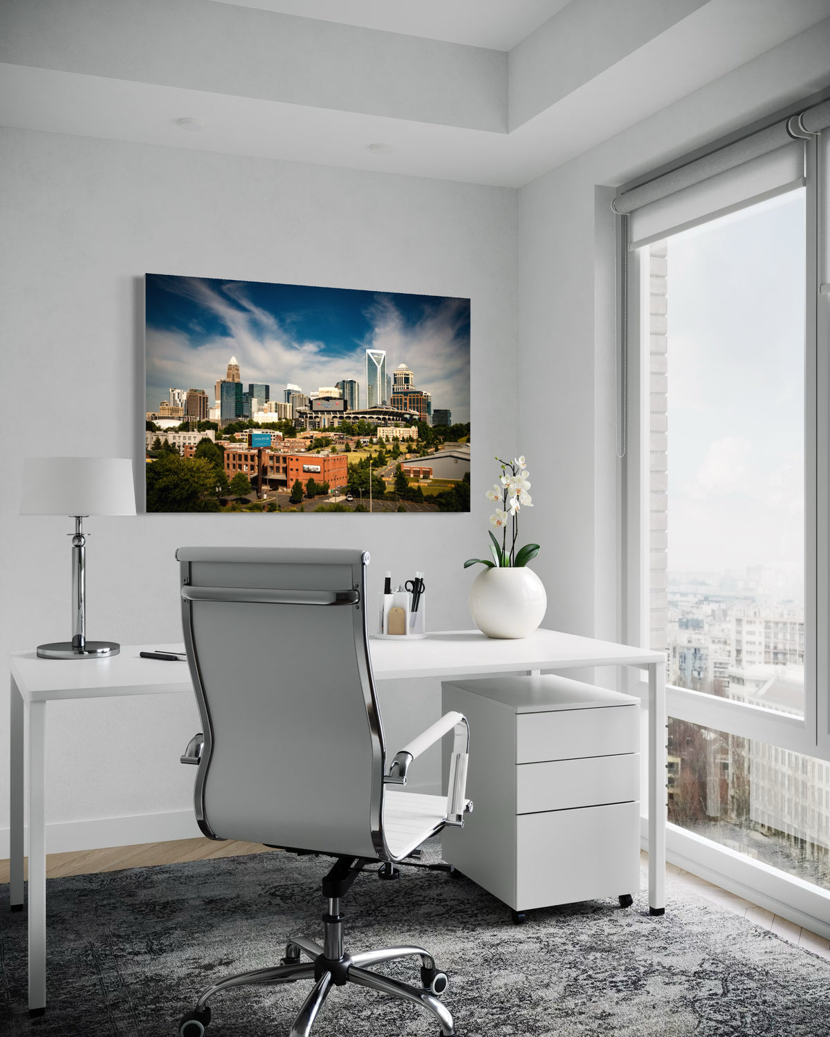 Charlotte skyline print above a white desk in a home office with a large window
