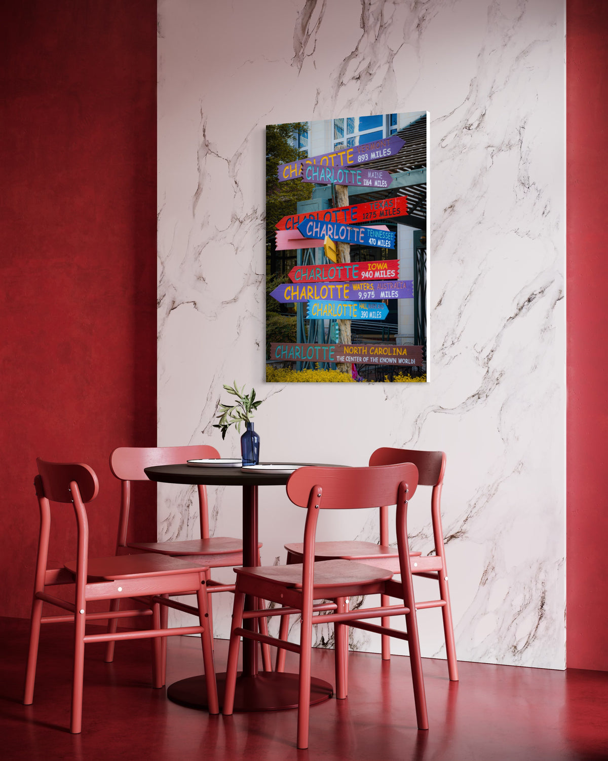 Directions print on a white marble wall above a round table with red chairs