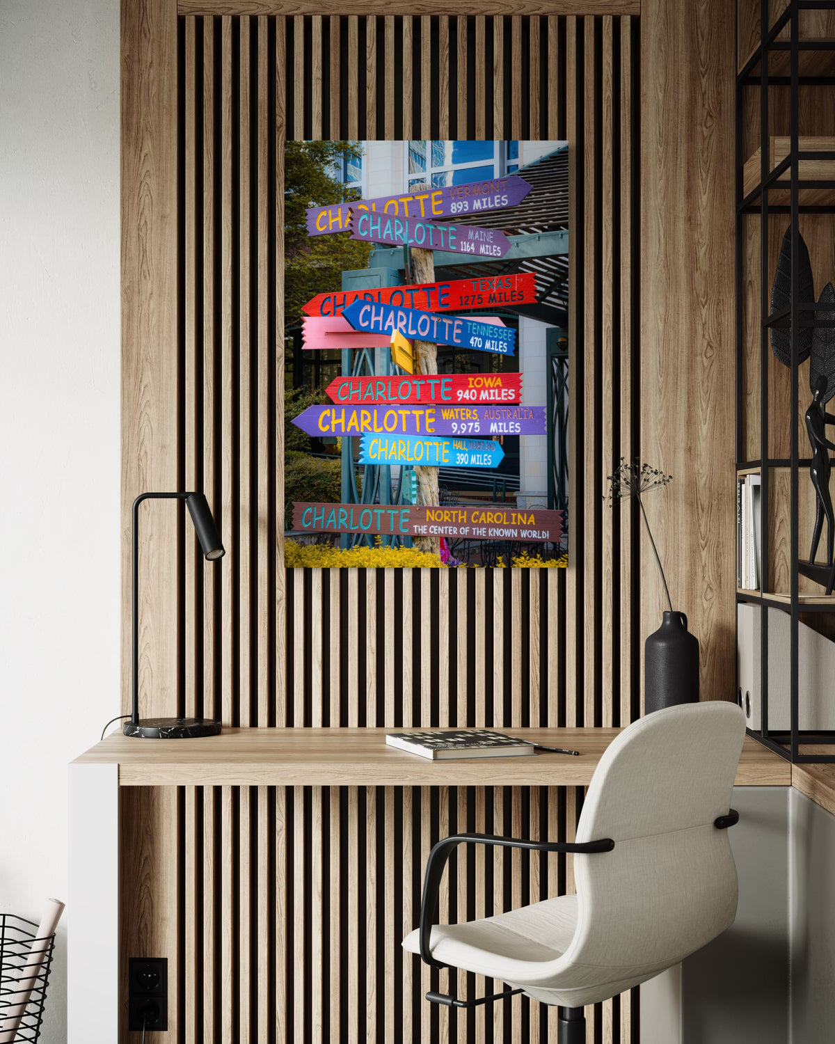 Directions print on a wood slat wall above a desk with a black lamp and a white office chair