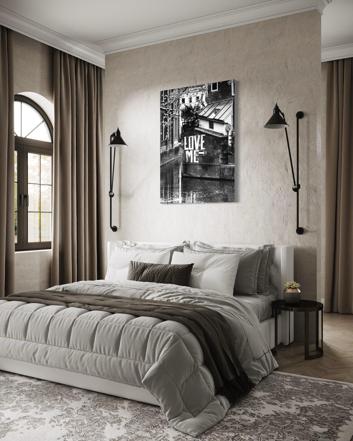 Love Me print on a plaster bedroom wall above the bed, between two black wall lamps